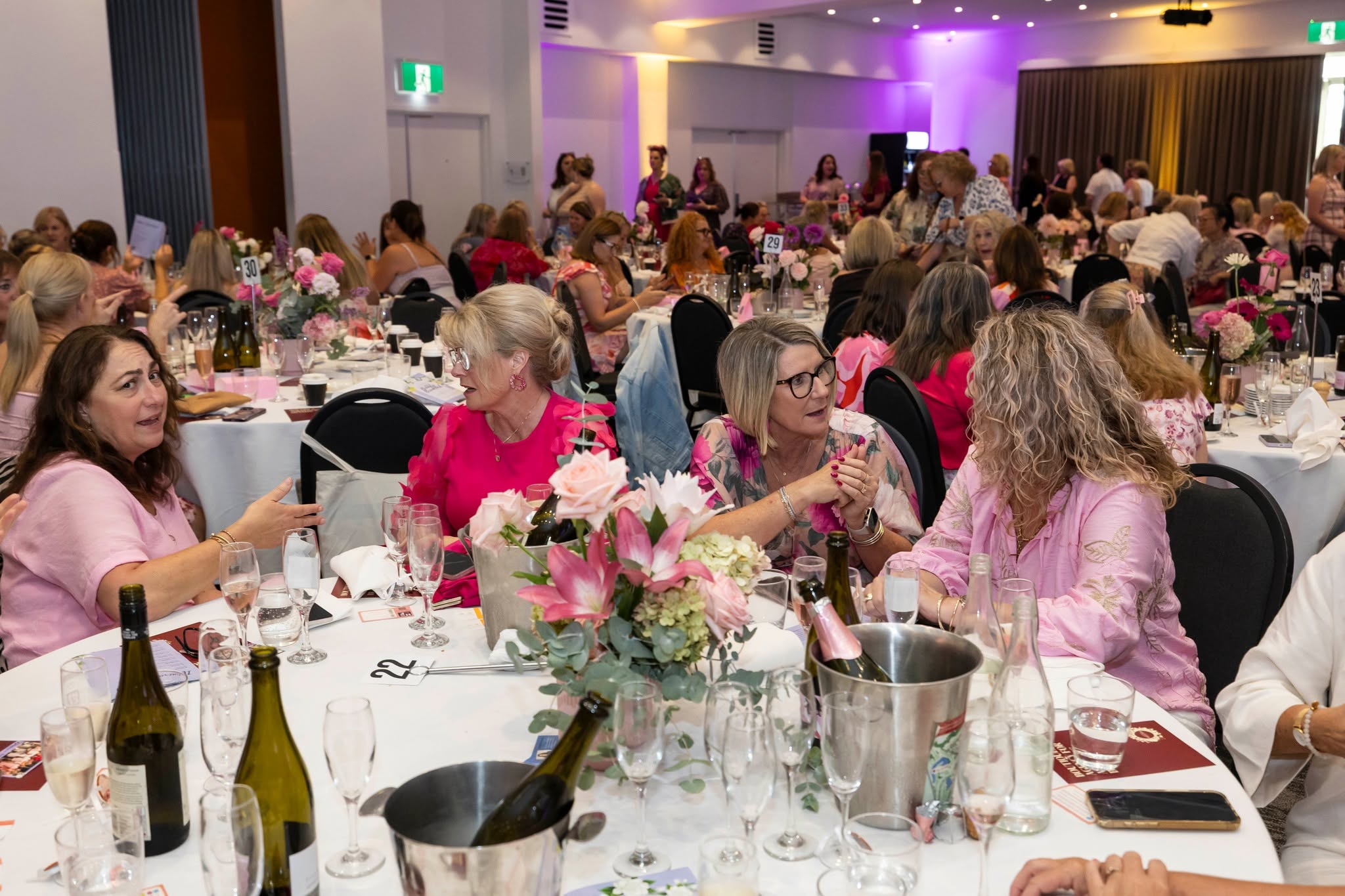 Guests enjoying the 2026 HBCF Bubbly Breakfast at tables decorated with pink flowers