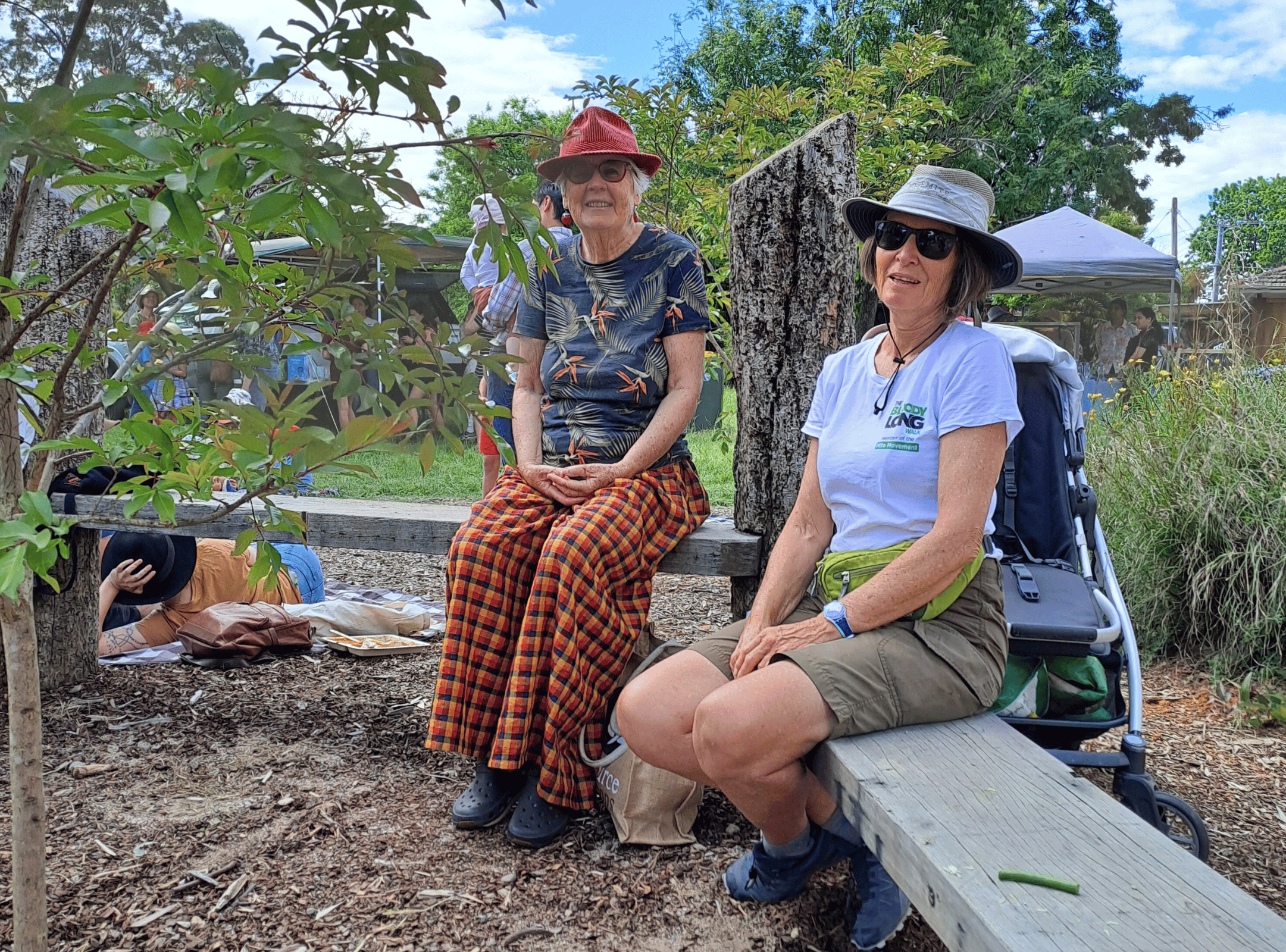 Two women sitting on wooden benches